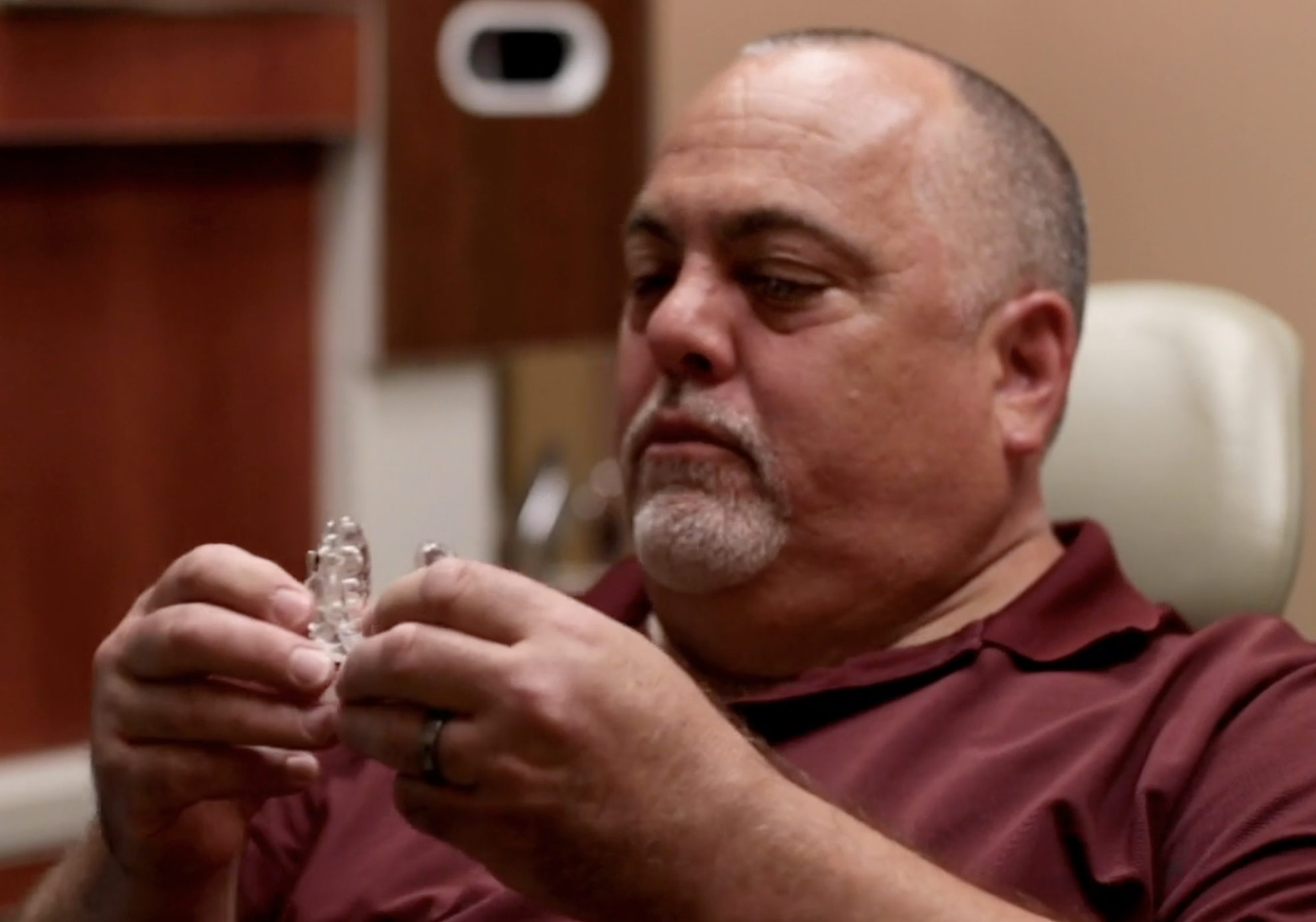 a man looks at his sleep apnea oral appliance