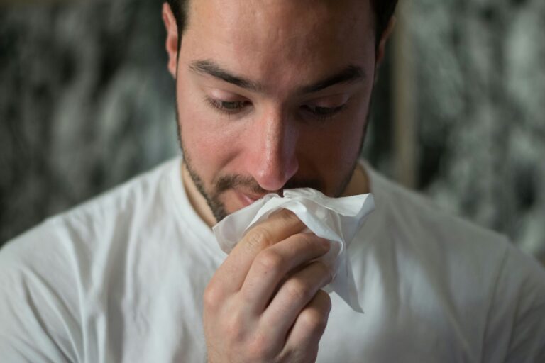 Man with Allergies using a tissue